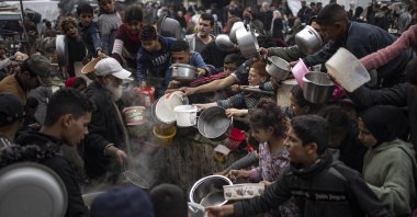 Palestinians line up for a meal in Rafah, Gaza Strip, Palestine, Dec. 21, 2023. (AP Photo)