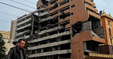 A pedestrian walks past the bomb-damaged building of the former Yugoslavia federal military headquarters in Belgrade, Serbia, March 24, 2010. (AFP Photo)