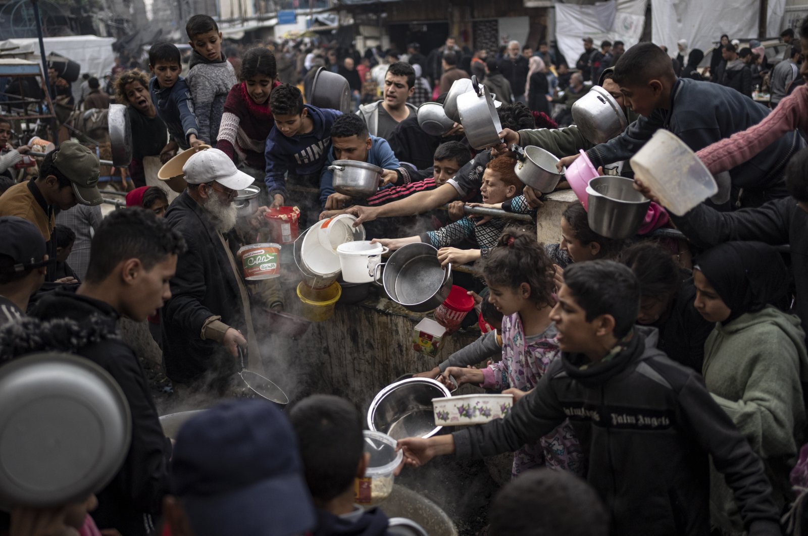Palestinians line up for a meal in Rafah, Gaza Strip, Palestine, Dec. 21, 2023. (AP Photo)