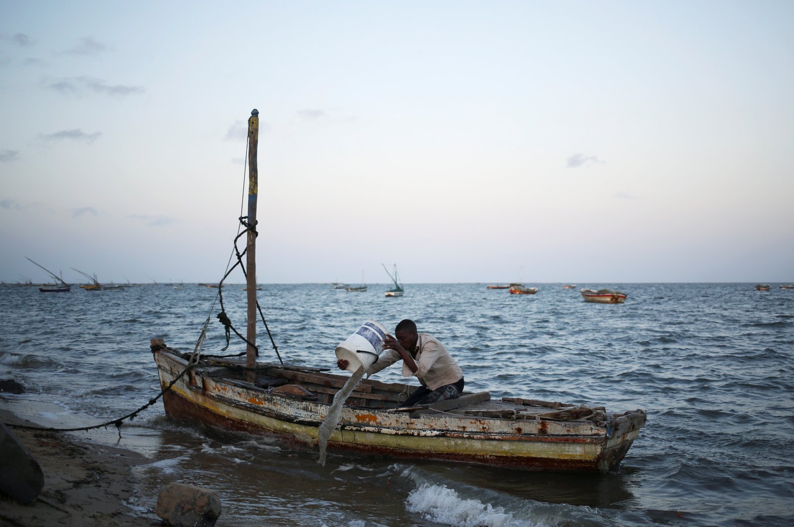 A fishermen empties his boat from water, Maputo, Mozambique, Sept. 1, 2019. (Reuters Photo)
