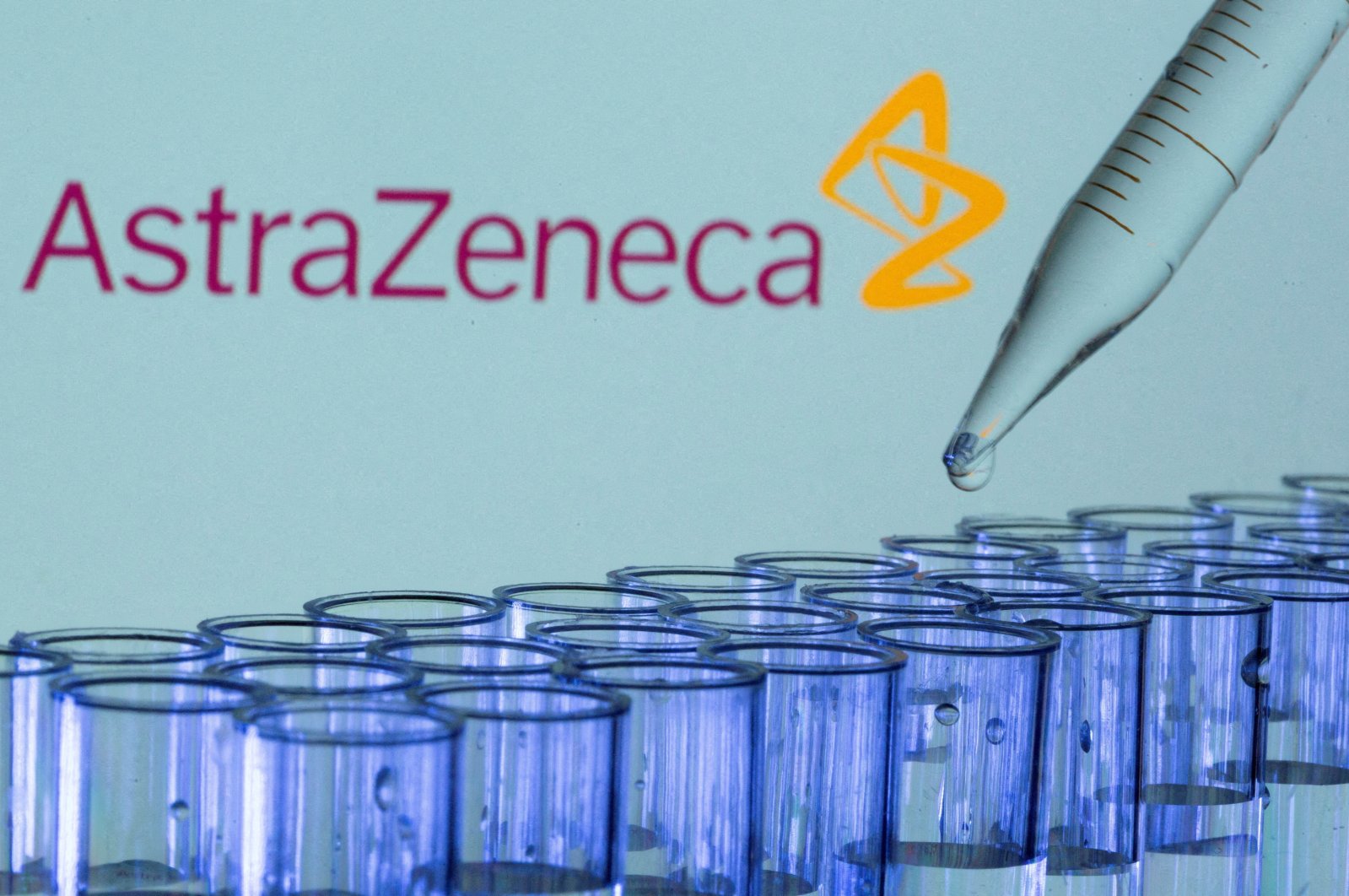 Test tubes are seen in front of a displayed AstraZeneca logo in this illustration taken, May 21, 2021. (Reuters File Photo)