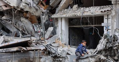 A Palestinian child plays on the ruins of a building destroyed by Israeli bombardments, Gaza City, Palestine, April 8, 2024. (AFP Photo)