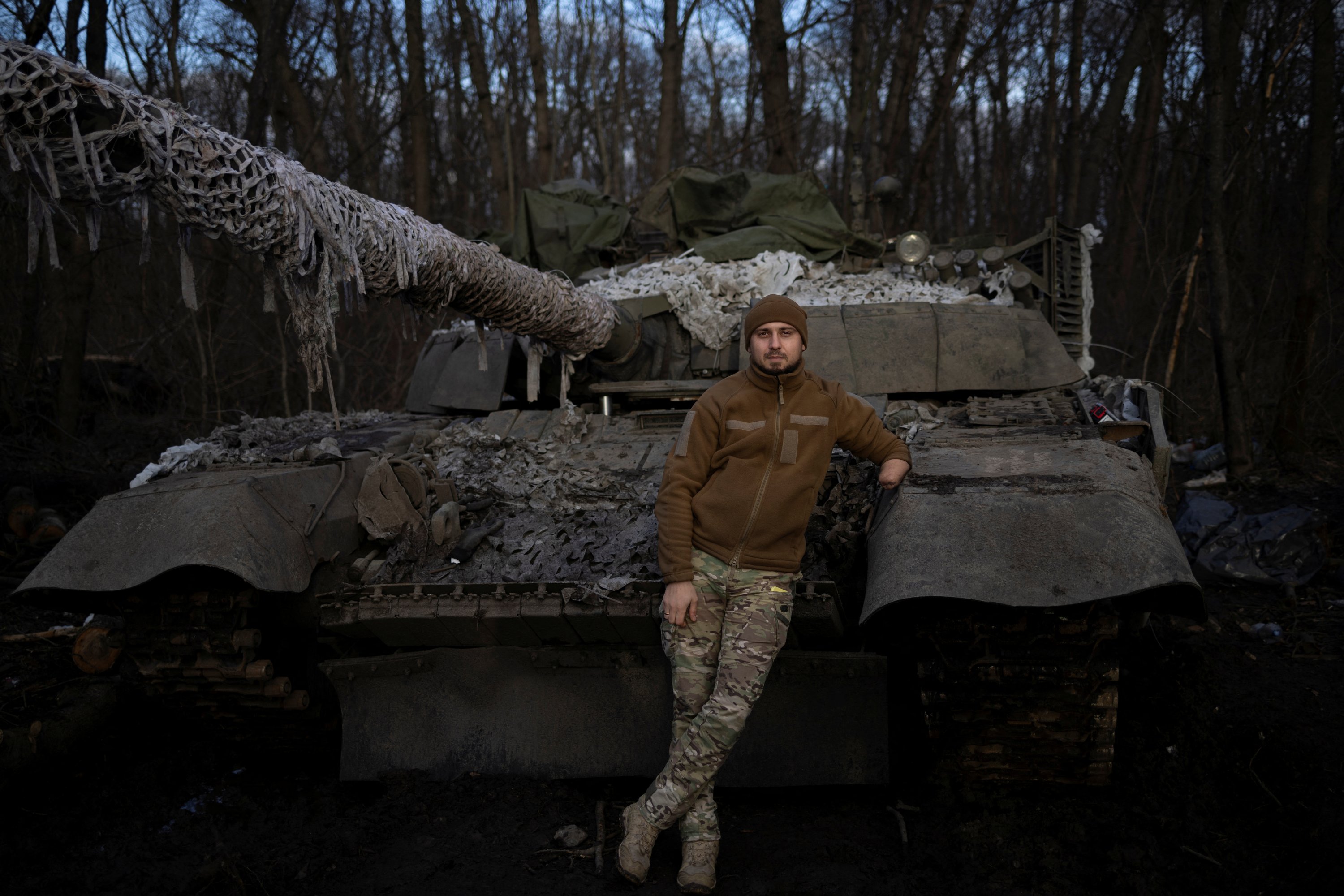 Mango, 28, the head of logistics of an Azov tank battalion who lost his hand in the defense of Mariupol and fell into Russian captivity, poses for a picture next to a tank at his base, amid Russia's attack on Ukraine, in the Donetsk region, Ukraine, Dec. 26, 2023. (Reuters Photo)