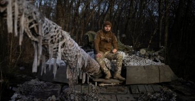 Mango, 28, the head of logistics of an Azov tank battalion who lost his hand in the defense of Mariupol and fell into Russian captivity, poses for a picture on top of a tank at his base in the Donetsk region, amid Russia&#039;s attack on Ukraine, Dec. 26, 2023. (Reuters Photo)