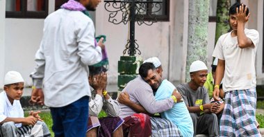 Rohingya refugees embrace each other after taking part in Eid al-Fitr prayers, marking the end of the holy month of Ramadan, at a temporary shelter in Meulaboh, Indonesia, April 10, 2024. (AFP Photo)