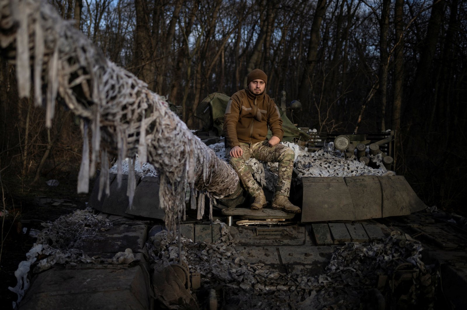Mango, 28, the head of logistics of an Azov tank battalion who lost his hand in the defense of Mariupol and fell into Russian captivity, poses for a picture on top of a tank at his base in the Donetsk region, amid Russia&#039;s attack on Ukraine, Dec. 26, 2023. (Reuters Photo)