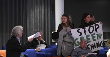Swedish climate activist Greta Thunberg and activists from the Fridays For Future movement protest with a banner reading "SAS stop greenwashing," Stockholm, Sweden, March 18, 2024. (AFP Photo)