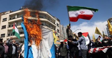Iranians burn an Israeli flag during a rally marking Quds Day and the funeral of members of the Islamic Revolutionary Guard Corps who were killed in a suspected Israeli airstrike on the Iranian Embassy complex in the Syrian capital Damascus, Tehran, Iran, April 5, 2024. (Reuters Photo)