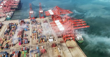 An aerial view shows gantry cranes and shipping containers at a port in Lianyungang, in eastern China's Jiangsu province, April 12, 2024. (AFP Photo)