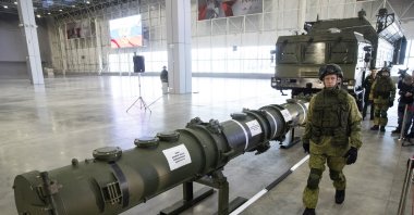 A Russian military officer walks past the 9M729 land-based cruise missile on display with its launcher, right, in Kubinka outside Moscow, Russia, Wednesday, Jan. 23, 2019. (AP File Photo)