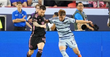Inter Miami's Lionel Messi (L) and Sporting Kansas City's Jake Davis fight for the ball during the first half at GEHA Field at Arrowhead Stadium, Kansas City, Kansas, U.S., April 13, 2024. (Reuters Photo)