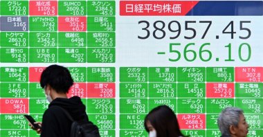 Pedestrians walk past an electronic board showing a share price of the Nikkei index of the Tokyo Stock Exchange, Tokyo, Japan, April 15, 2024. (AFP Photo)