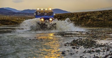 A mountain vehicle drives in water in the lakes of Erzincan, eastern Türkiye, April 15, 2024. (IHA Photo)