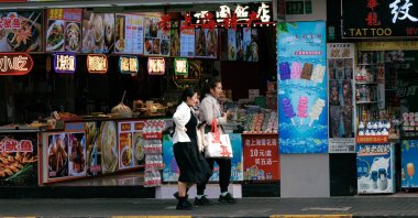 People walk past restaurants on a street in Shanghai, China, April 15, 2024. (EPA Photo)