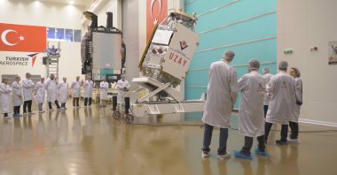 Developers inspect the IMECE satellite in an unspecified location, April 10, 2023. (Courtesy of Industry and Technology Ministry)