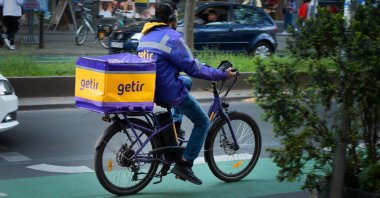 A courier from the delivery service Getir rides his bicycle, Berlin, Germany, May 20, 2023. (Reuters Photo)