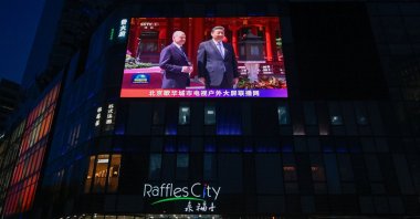 A large screen shows news coverage of Chinese President Xi Jinping (R) meeting German Chancellor Olaf Scholz, Beijing, China, April 16, 2024. (AFP Photo)
