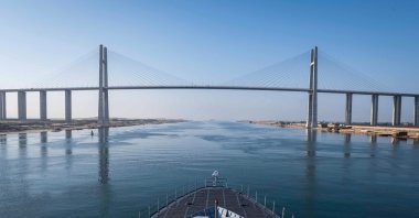 Turkish warship TCG Kınalıada is seen in front of the Suez Canal Bridge, also known as the Egyptian–Japanese Friendship Bridge, Al Salam Bridge, Al Salam Peace Bridge or Mubarak Peace Bridge in this photo released by the Defense Ministry on April 16, 2024. (AA Photo via Defense Ministry)