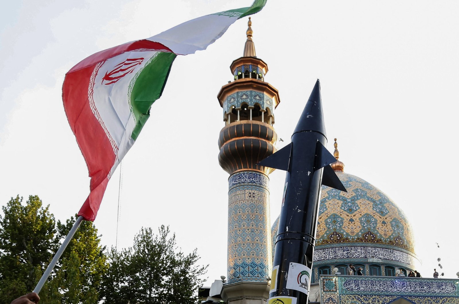 Iranian lift up a flag and the mock up of a missile during a celebration following Iran&#039;s missiles and drones attack on Israel, at Palestine square in central Tehran, Iran, April 15, 2024. (AFP Photo)