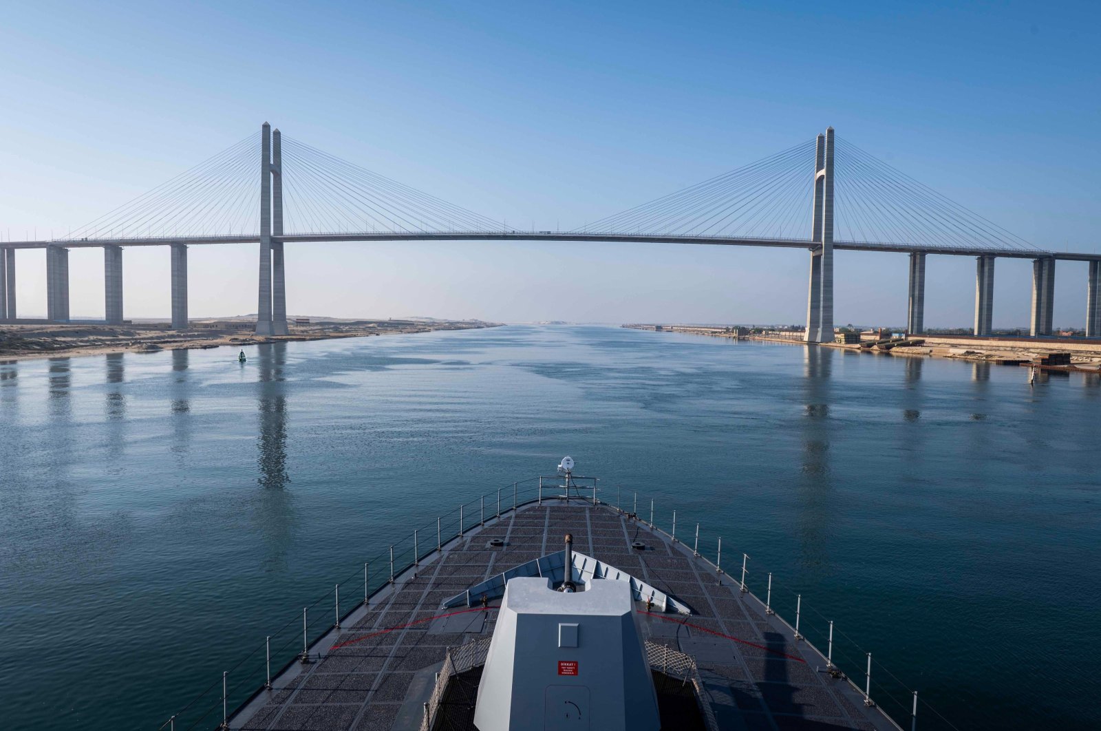 Turkish warship TCG Kınalıada is seen in front of the Suez Canal Bridge, also known as the Egyptian–Japanese Friendship Bridge, Al Salam Bridge, Al Salam Peace Bridge or Mubarak Peace Bridge in this photo released by the Defense Ministry on April 16, 2024. (AA Photo via Defense Ministry)