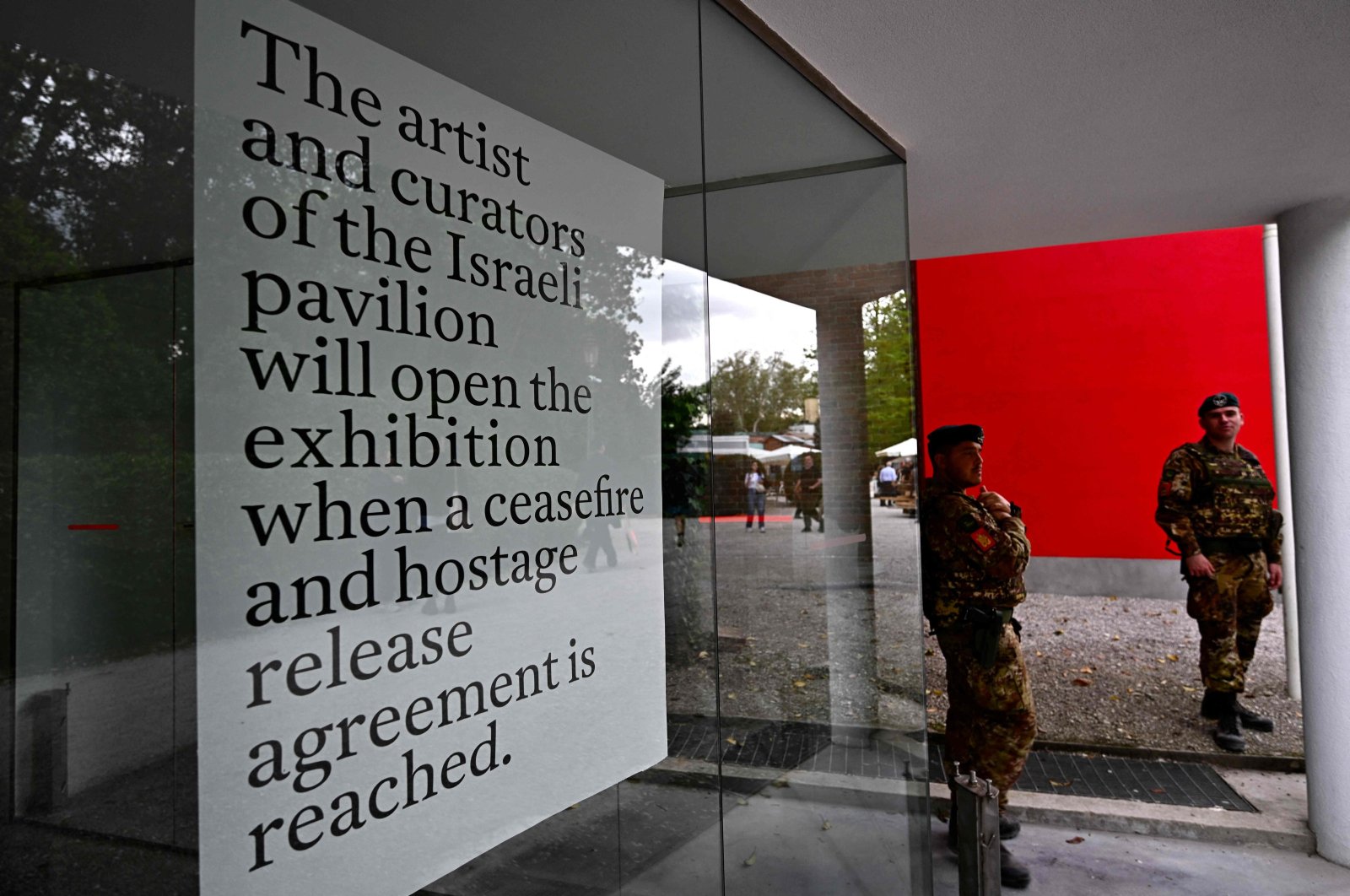  Italian soldiers stand guard in front of  Israel&#039;s pavilion during the pre-opening of the Venice Biennale art show, April 16, 2024. (AFP Photo)