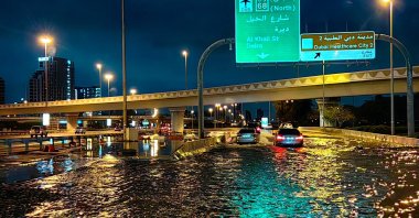 Motorists drive along a flooded street following heavy rains, Dubai, UAE, April 17, 2024. (AFP Photo)