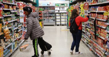 People shop at a store in London, Britain, March 20, 2024. (EPA Photo)