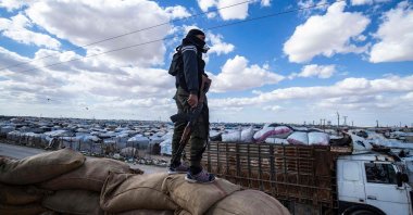 A YPG/PKK terrorist watches the al-Hol camp in Hassakeh, Syria, March 18, 2021. (AFP Photo)