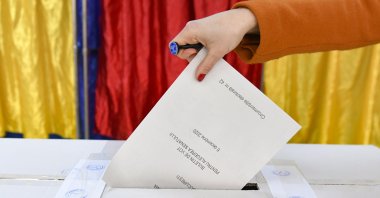 A woman casts her vote in Romania&#039;s legislative election, in Bucharest, Romania, Dec. 6, 2020. (AP File Photo)