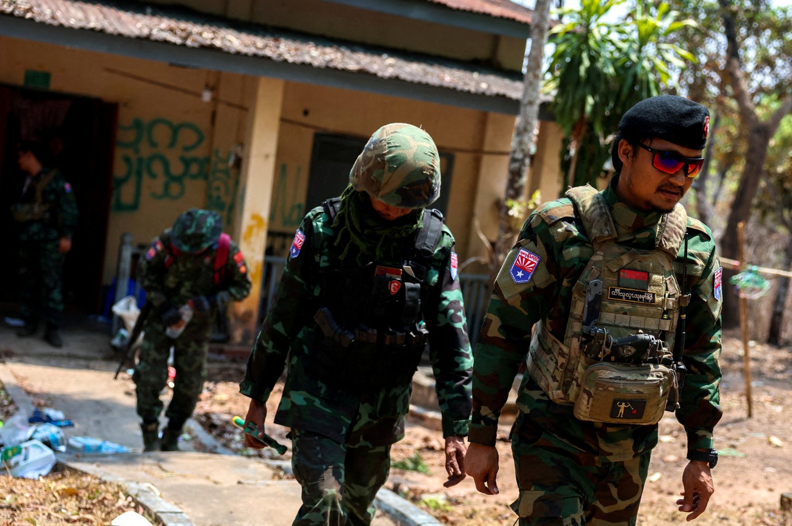 LT Saw Kaw, a soldier of the Karen National Liberation Army (KNLA) in charge of the Cobra column, walks with his team members after inspecting the house of a high-rank Myanmar soldier at Infantry Batallion 275, Myawaddy, Myanmar, April 15, 2024. (Reuters Photo)