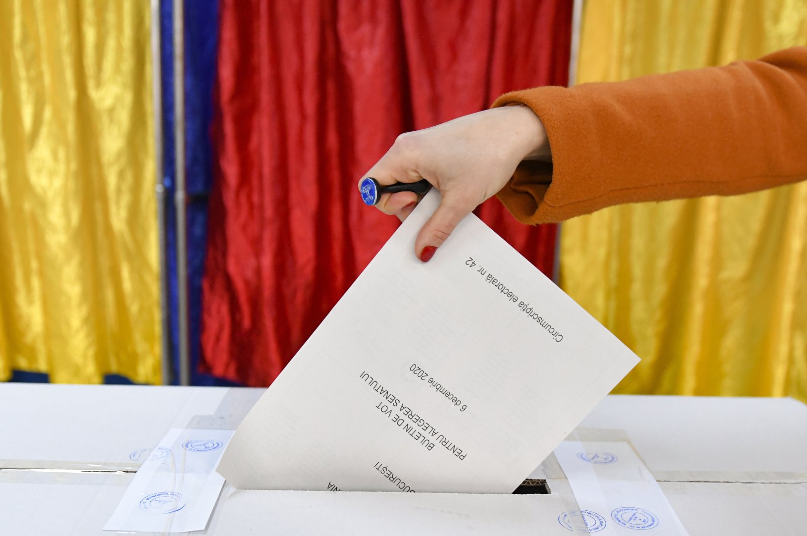 A woman casts her vote in Romania&#039;s legislative election, in Bucharest, Romania, Dec. 6, 2020. (AP File Photo)