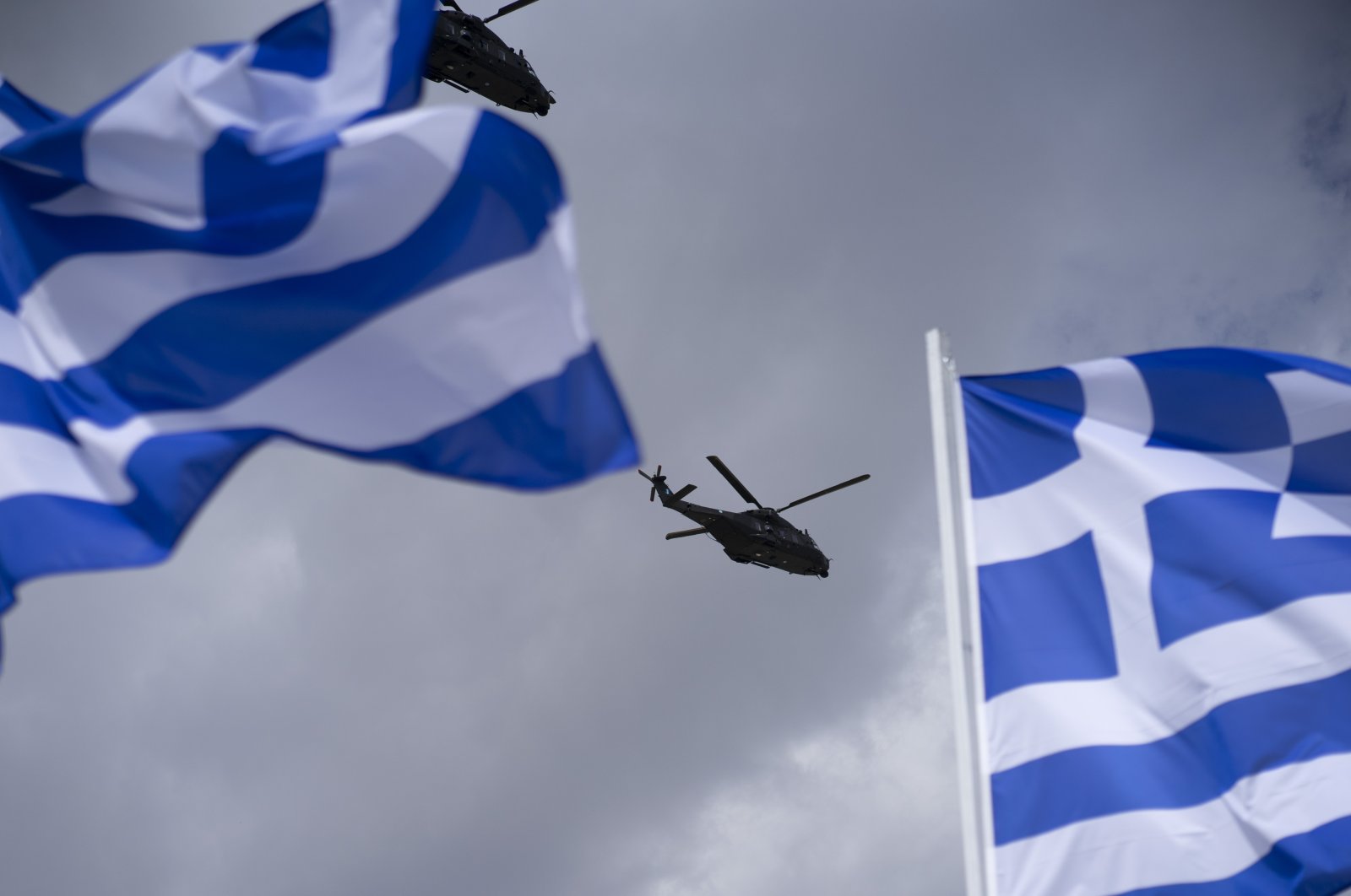 Two military helicopters fly over during a military parade marking Independence Day, Athens, Greece, March 25, 2024. (Reuters Photo)