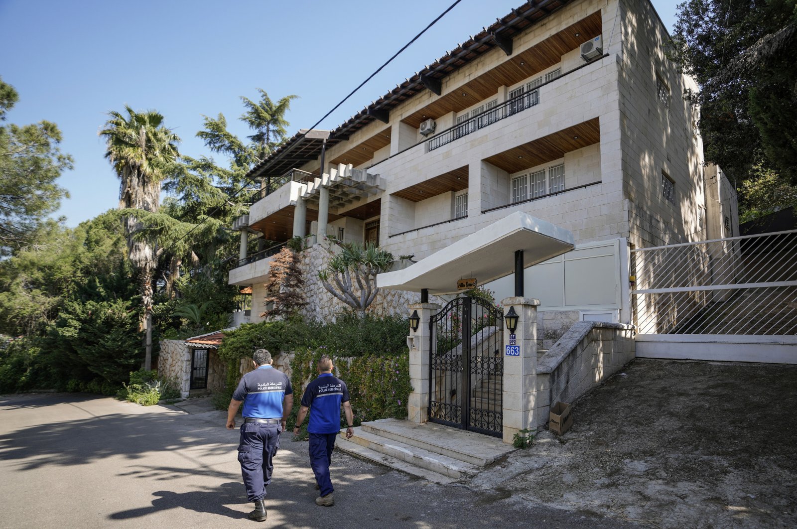 Municipal police officers patrol outside a villa where the Lebanese money changer Mohammad Srour, 57, was found tortured and killed in the Monte Verdi neighborhood, Beit Meri, Lebanon, April 16, 2024. (AP Photo)