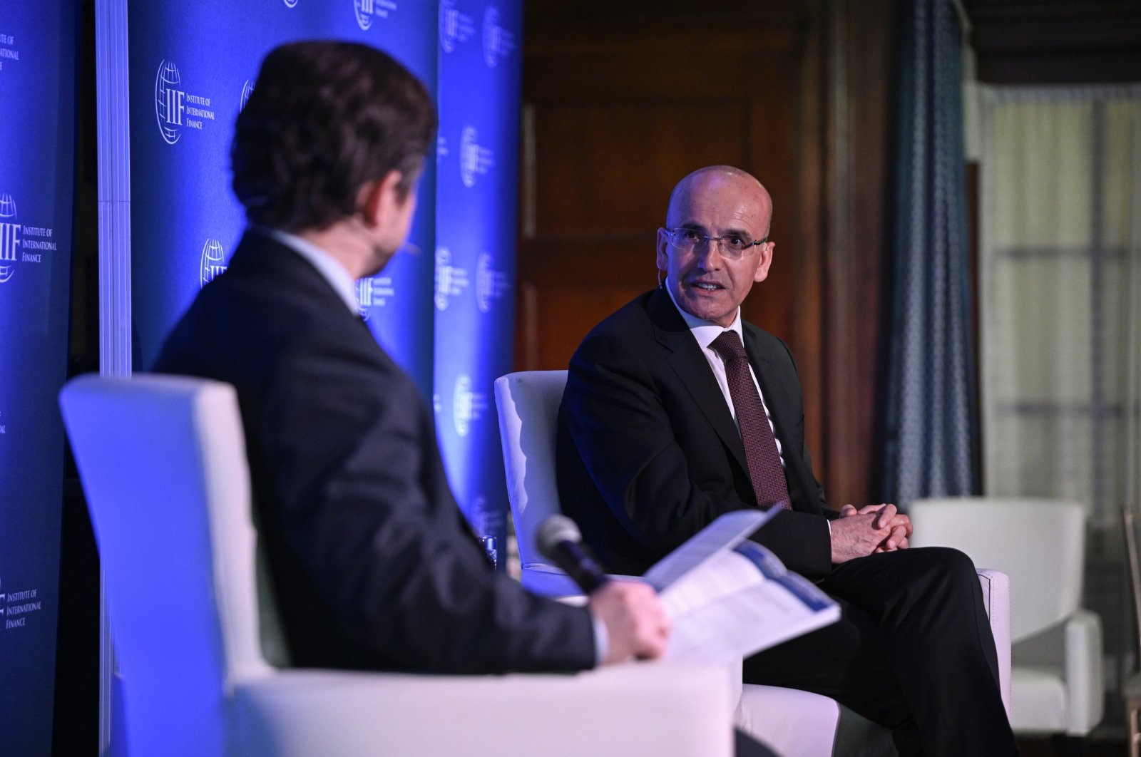 Treasury and Finance Minister Mehmet Şimşek (R) delivers a speech at the "Global Outlook Forum" organized by the Institute of International Finance (IIF) in Washington, U.S., April 17, 2024. (AA Photo)