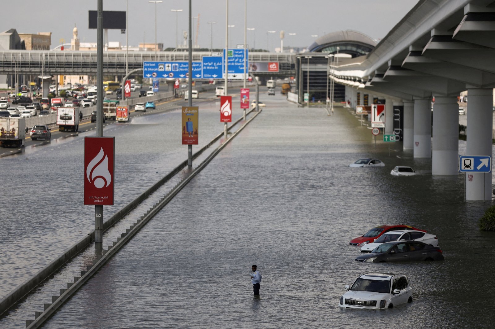 A person stands surrounded by flood water caused by heavy rains, Dubai, United Arab Emirates (UAE), April 17, 2024. (Reuters Photo)