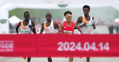 Chinese runner He Jie, Ethiopian Dejene Hailu Bikila and Kenyans Robert Keter and Willy Mnangat take part in a half-marathon, Beijing, China, April 14, 2024. (Reuters Photo)