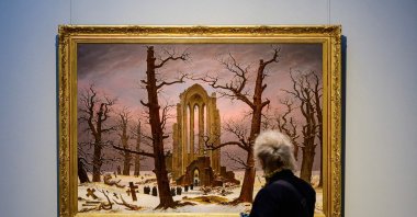 The painting "Monastery Cemetery in Snow," a copy by an unknown artist of a painting by German painter Caspar David Friedrich (1774-1840), is on display as part of the "Infinite Landscapes" exhibition at the Alte Nationalgalerie museum, Berlin, Germany, April 17, 2024. (AFP Photo)