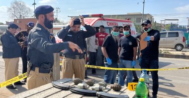 Police officers survey the site after a suicide blast, Karachi, Pakistan, April 19, 2024. (Reuters Photo)