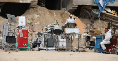 Crew members from the Palestinian ministries of health, justice, and interior stand next to medical equipment as they search among the rubble for possible bodies after the Israeli army left the Al-Shifa Medical Hospital Complex in Gaza City, April 8, 2024. (EPA Photo)