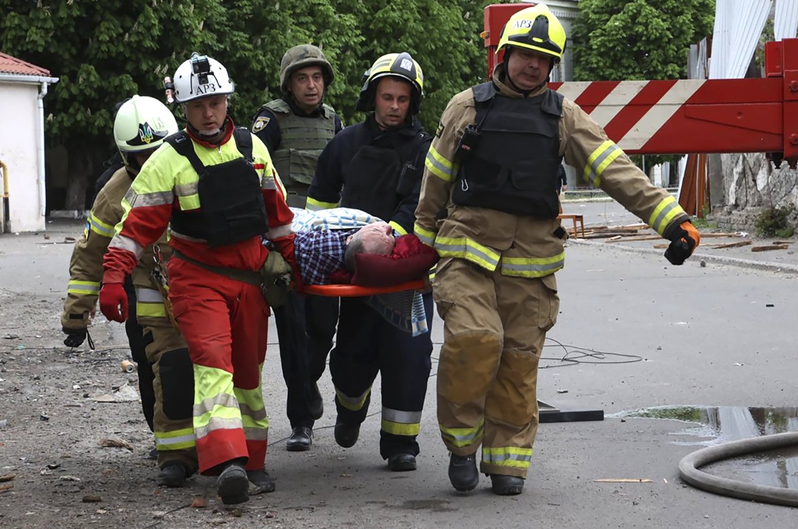 In this photo provided by the Ukrainian Emergency Service, rescuers and ambulance workers carry a person at the scene of a Russian attack, Dnipro, Ukraine, April 19, 2024. (AP Photo)