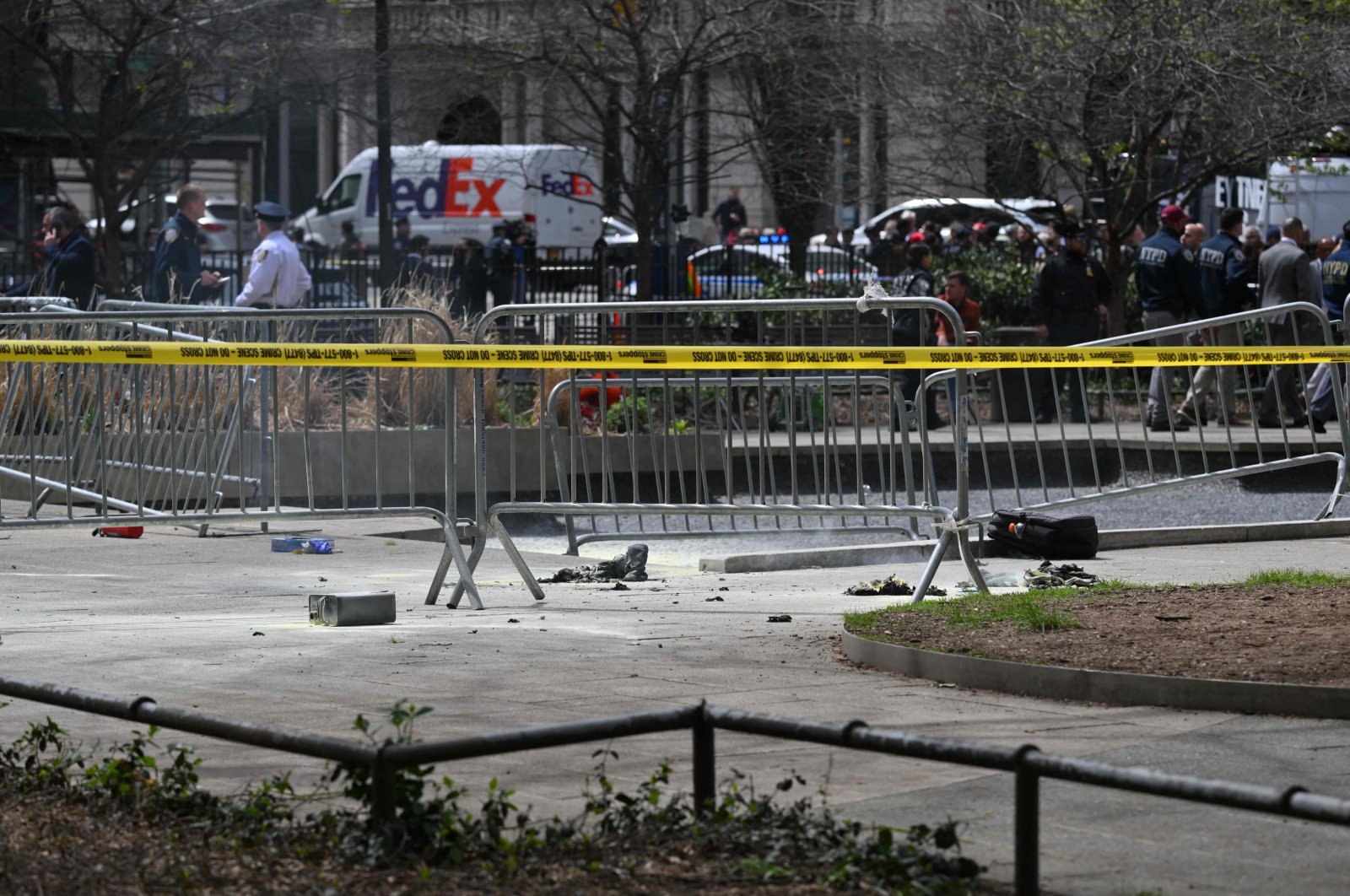 Police crime tape is strung at the site across from Manhattan Criminal Court in New York City after a man reportedly set himself on fire during the trial of U.S. President Donald Trump, April 19, 2024. (AFP Photo)