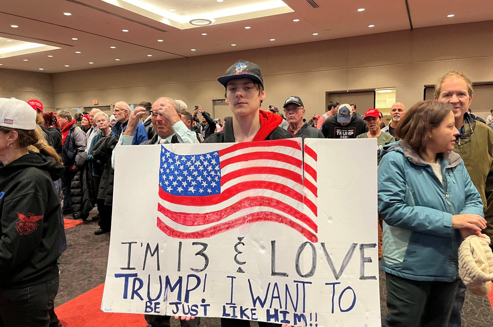 A young Donald Trump supporter holds up a sign, at a Trump rally in Green Bay, Wisconsin, U.S., April 2, 2024. (Reuters Photo)