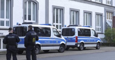 Police officers stand near a building that is being searched in Solingen, Germany, Wednesday April 17, 2024. (DPA PHoto)
