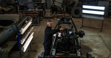 Portuguese Association of Old Military Vehicles’ technician Jose Nascimento, works on the restoration of a Humber military vehicle at a military warehouse in Oeiras, Portugal, March 26, 2024. (AFP Photo)