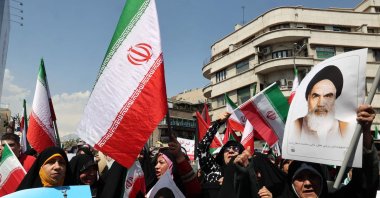 Iranians wave the flags of Palestine and Iran as they gather during an anti-Israel demonstration after the Friday noon prayer in Tehran, Iran, April 19, 2024. (AFP Photo)