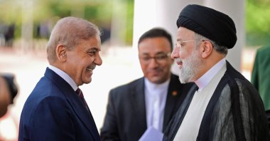 Iran’s President Ebrahim Raisi (R) being greeted by Pakistan's Prime Minister Shehbaz Sharif in Islamabad, Pakistan, April 22, 2024. (AFP Photo)