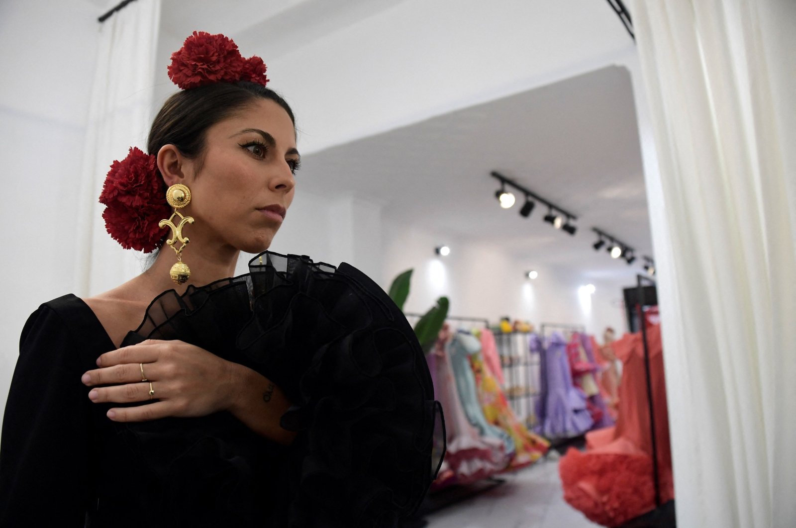 Customer Virginia Cuaresma tries on a flamenco dress at Luis Fernandez&#039;s workshop in Seville, Spain, April 8, 2024. (AFP Photo)