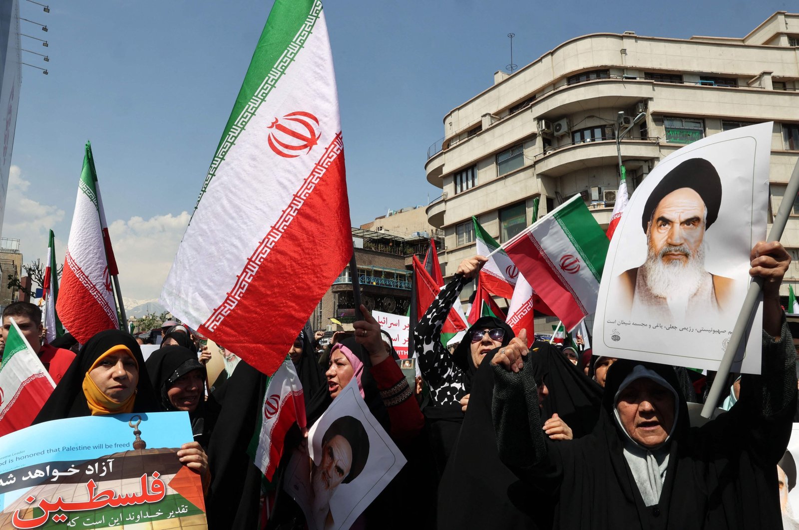 Iranians wave the flags of Palestine and Iran as they gather during an anti-Israel demonstration after the Friday noon prayer in Tehran, Iran, April 19, 2024. (AFP Photo)