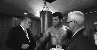 Dr. Leo Lemieux checks the blood pressure of heavyweight champion Cassius Clay, (C) as Maine Boxing Commission member Duncan MacDonald, (R), looks on, Maine, U.S., May 18, 1965. (AP Photo)