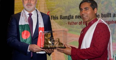 Turkish Labor and Social Security Minister Vedat Işıkhan (L) hands Ambassador M. Amanul Haq of Bangladesh a gift for the occasion of Bangladesh's Independence Day, Ankara, Türkiye, April 22, 2024. (AA Photo)